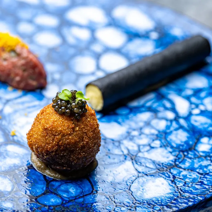 A dish at ars served on a blue plate